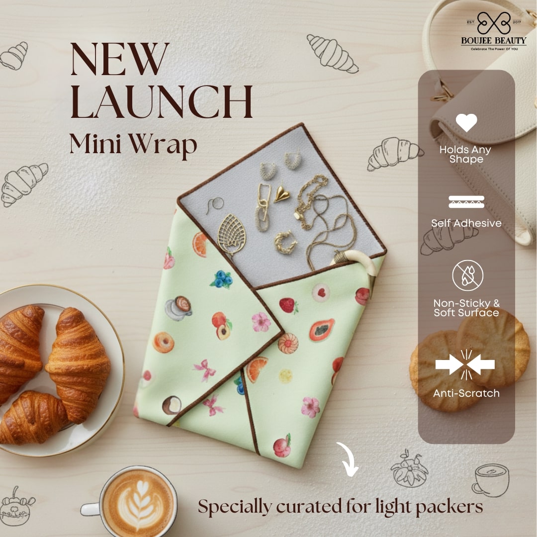 Boujee Beauty Mini wrap with jewelry on a light surface with croissants and coffee.