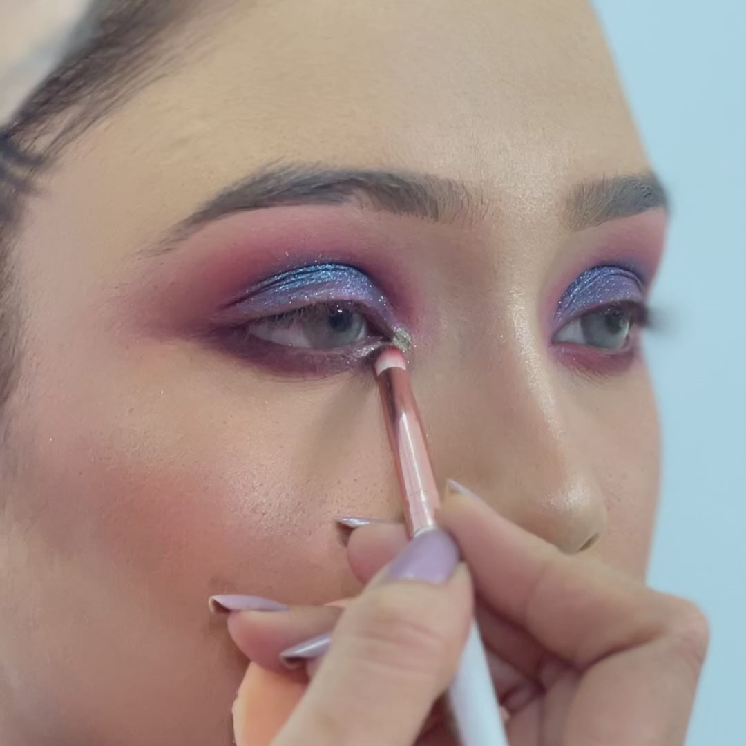 artist using small pencil brush on female model