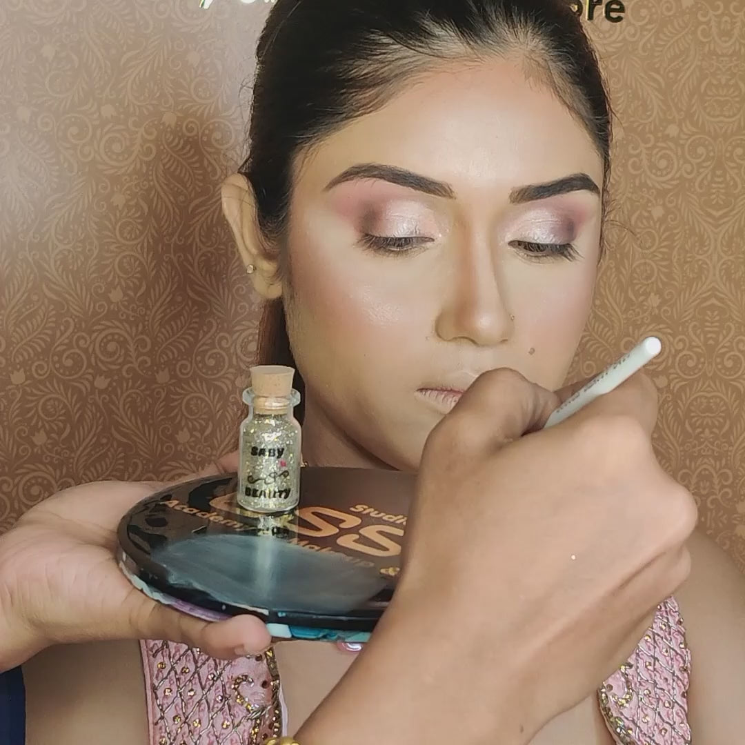 artist using small blending brush on model eyelids
