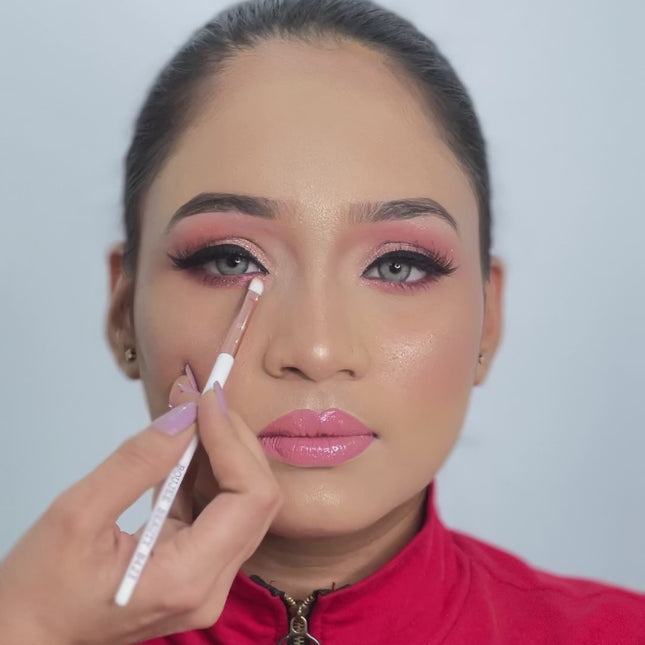 artist using small flat applicator brush on model eyes