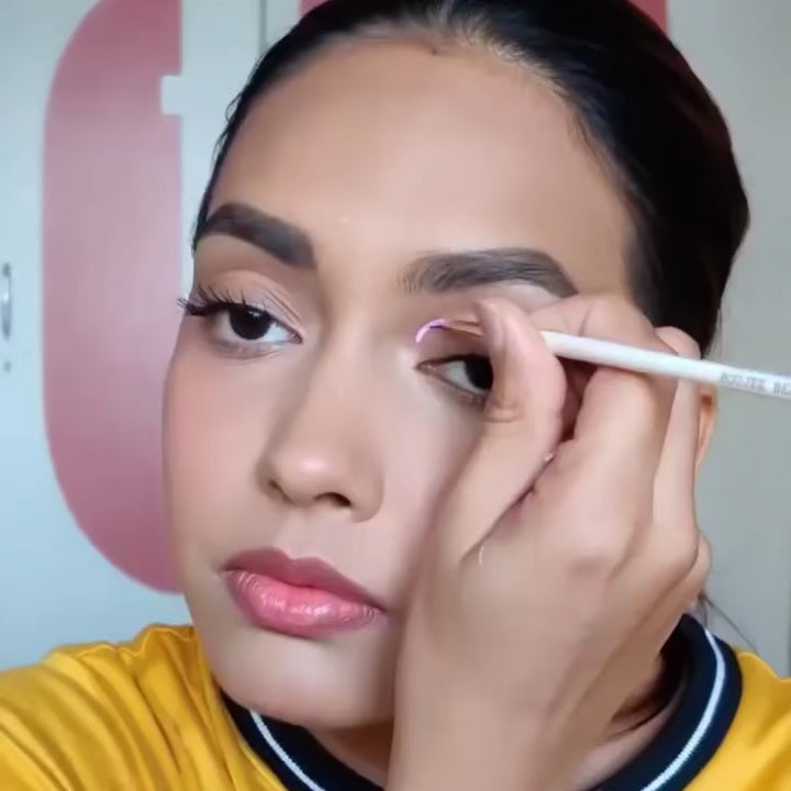 A girl using eye liner brush in the video