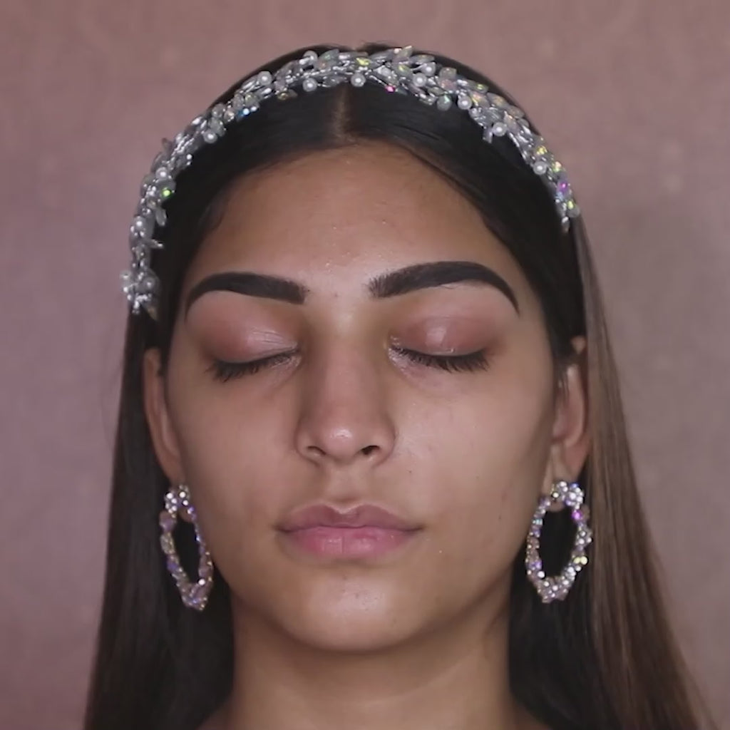makeup artist using concealer brush on model eyelids