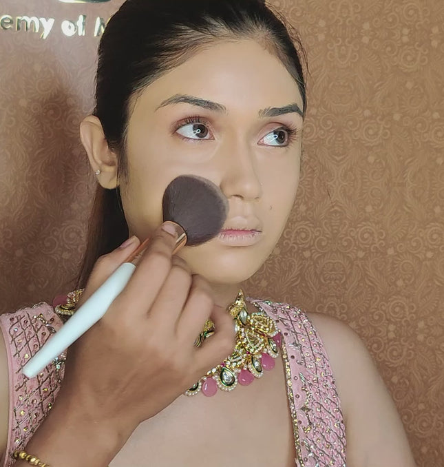 artist using blush brush on model face