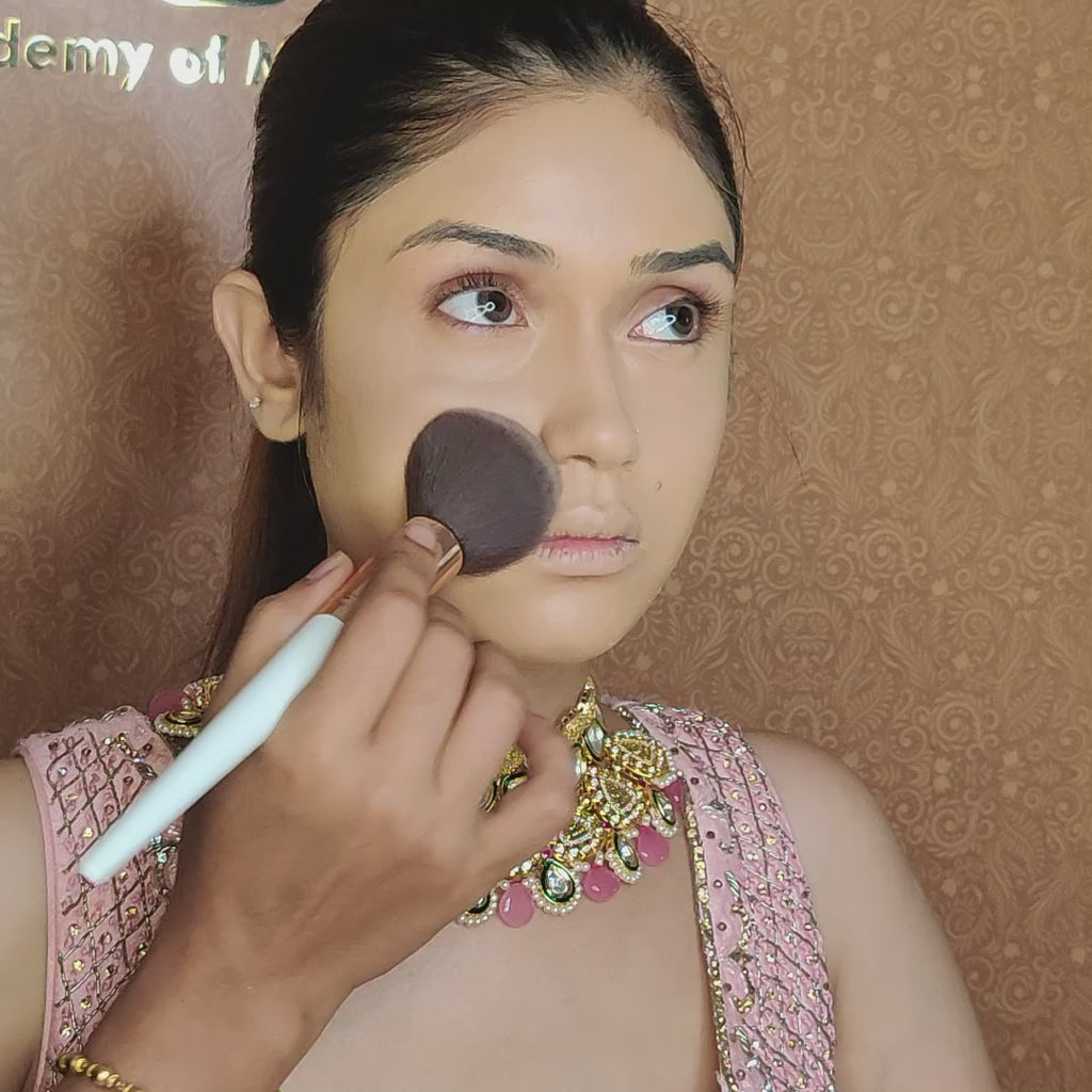 artist using blush brush on model face