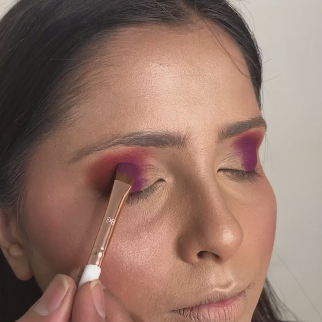 artist using flat eyeshadow applicator brush on model eyes