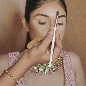 artist using fluffy blending brush on model eyes