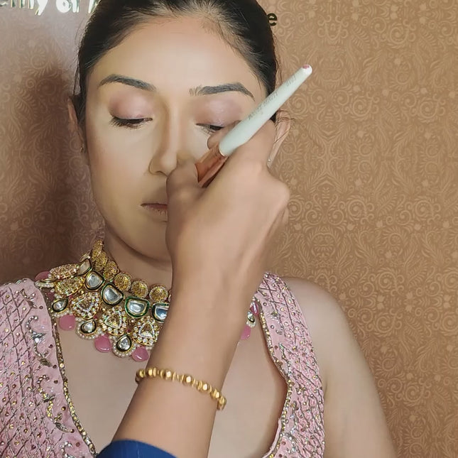 artist using bronzer brush on model face