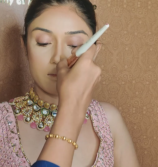 artist using bronzer brush on model face